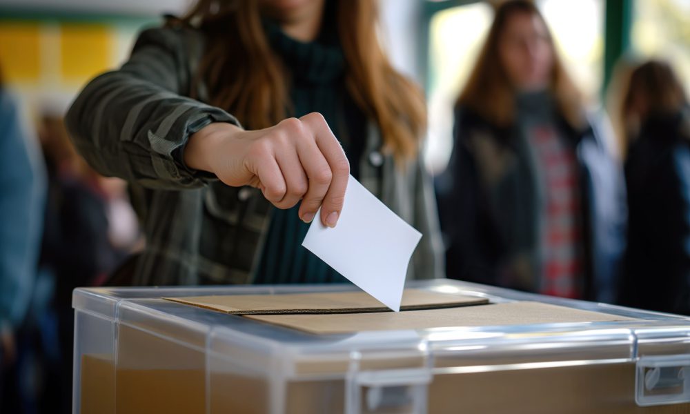 Person Depositing Voting Card Into Ballot Box for Casting Vote in Democracy